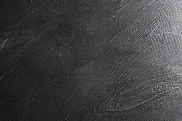 Superficie con texture materica molto irregolare dipinta di colore grigio-nero; spazio per testo