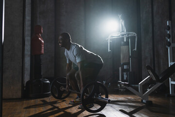 Obraz premium Fitness workout healthy lifestyle. African American man bodybuilder weightlifter picking up barbell doing heavy deadlifts in gym Weightlifting workout weight training muscles Man doing sports exercise