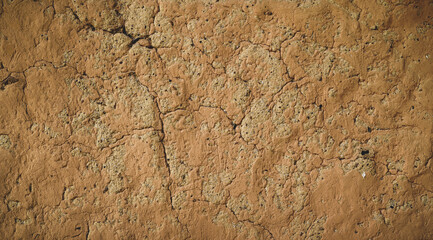 Wall of old mud house. Clay wall, surface texture. Close up.