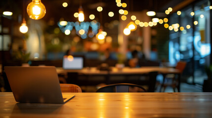 Laptop on wooden table in a cozy cafe with warm lights. ..