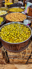 Varieties of olives in barrels in the delicatessen section