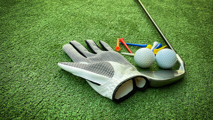 Golf balls and equipment on the grass.