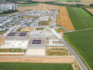 Neues Baugebiet mit Häusern und Schulneubau am Stadtrand