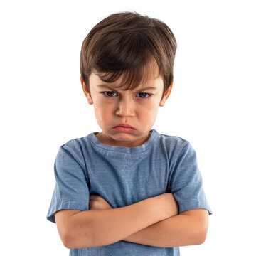 A frustrated little boy with his arms crossed and a deep frown, standing against a white backdrop.