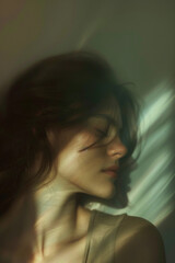 A silence young woman with long hair illuminated by soft abstract lighting. Photography with concept of mental well-being