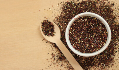 Fruit tea on the background of the table. Top view of tea in white dishes. Tea composition. Ingredients for a hot drink, close-up. Fruit tea, container and bamboo spoon on a light wooden background