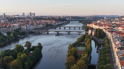 Fototapeta premium Photo of Prague old city taken from the sky with a drone. Bridges over the river.Prague at sunrise. Prague cityscape.