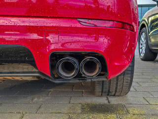 red car rear bumper with exhaust pipes 