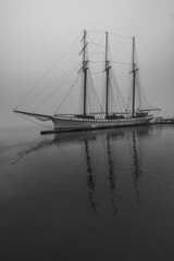 A boat on the pier in morning fog on the Toronto harbour front at Lake Ontario in Ontario, Canada