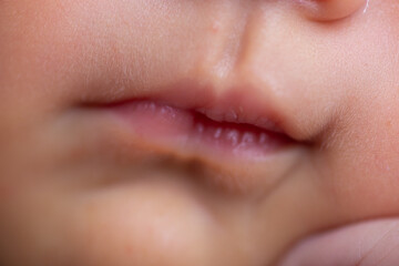 Fototapeta premium Little feet and hands and head Newborn baby body part details close up 