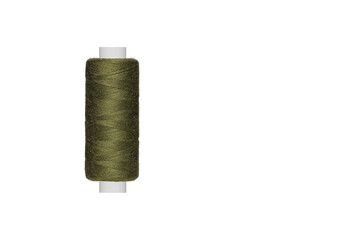 green spool of sewing thread isolated on white background close up