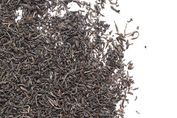 Black long tea on a white background. Top view of dried tea leaves. Tea composition. Ingredients for a hot drink, close-up. Background. Presentation of the type and variety of tea