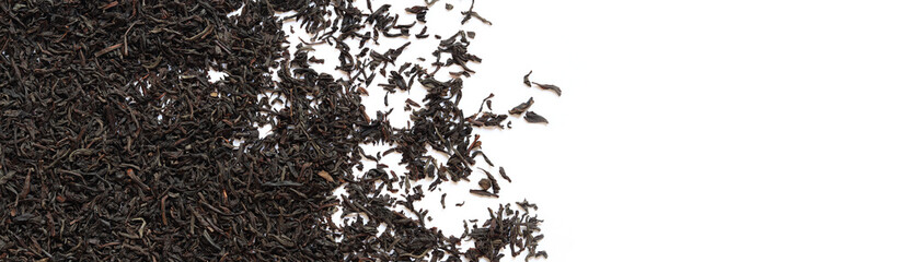 Black long tea on a white background. Top view of dried tea leaves. Tea composition. Ingredients for a hot drink, close-up. Background. Presentation of the type and variety of tea