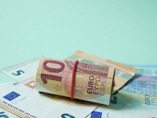 Macro, euro bills on green background, economy, spending or savings concept.