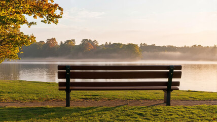 Fototapeta premium Tranquil Lake Morning with Empty Bench and Autumnal Trees - Peaceful Nature Photograph at Dawn