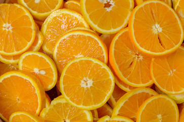 Colorful orange citrus fruit slices background top view
