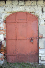 Old rusty metal door with a bolt. Doorway with old iron metal door.
