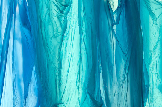 disposable plastic bags background, close-up, plastic waste, abstract vertical crumpled texture