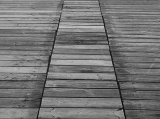 Wooden floor on the beach affected by wind and salt water, black and white picture