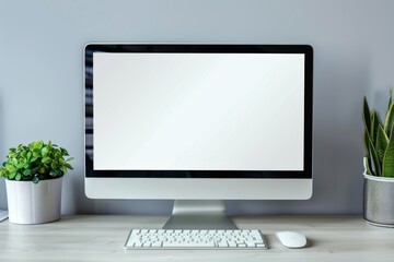 Mockup of a blank computer screen on a modern office desk with plants