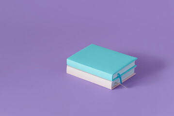 Two color books on a pastel purple background with soft shadow, copy space. Book Lovers Day concept