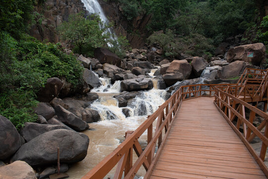 wooden foot bridge made for the tourists over the canyon where mighty lodh waterfalls plunges in the river gorge, jharkhand, india