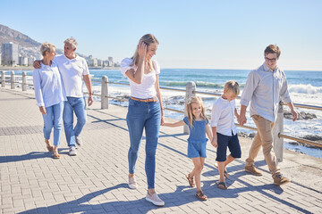 Family, walking and generations for love on beach, promenade and happy support in outdoor. Parents, grandparents and children for holding hands on vacation, bonding and holiday for seaside freedom © Alex Shared/peopleimages.com
