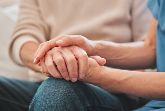 Holding hands, support and nurse with patient for medical diagnosis at consultation with comfort. Healthcare, empathy and caregiver with person for compassion, kindness or hope with bad news.