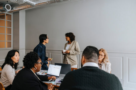 Male and female entrepreneurs discussing in meeting room at office