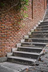 stairs by a brick wall on a steep street in the old town, time for travel and preservation of heritage