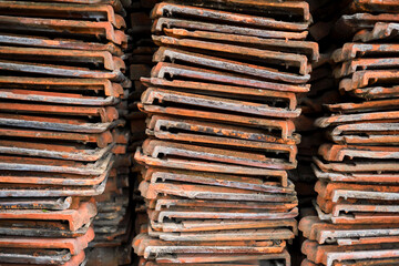 Old roof tiles stacked in a warehouse, concept of recycling and reusing things, renovation or reconstruction of buildings