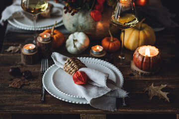 Atmospheric autumn elegant beautiful table setting with pumpkins for a wedding or thanksgiving...