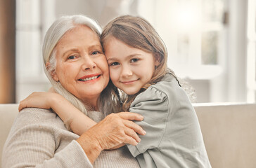 Grandma, girl and portrait on sofa for hug, love and relationship development at home. Senior...