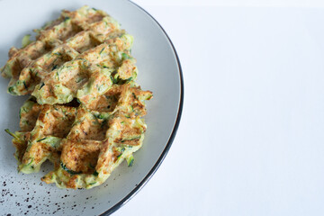 Zucchini waffles on a plate. Choice for healthy, diet-friendly meals and nutritious breakfast ideas. Great for culinary, healthy living, or food photography projects.