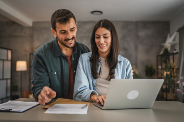 Adult woman work from home while her boyfriend hug and stand with her