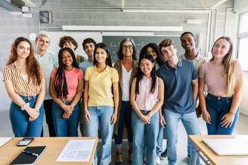 Portrait group of multiracial high school students with senior teacher in classroom. Education and youth community concept