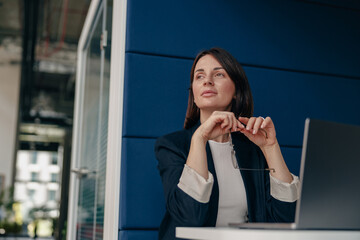 Confident businesswoman planning strategy in modern office with concentration and innovation