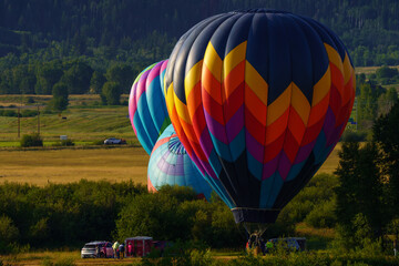 several hot air balloons being set up for flight in the mountains, Steamboat Colorado