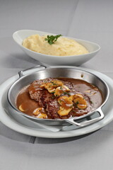 Filet mignon escalope with Madeira sauce and mushrooms with mashed potatoes