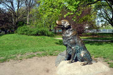 Warsaw, Poland. Dog statue. Warm, spring day at Mokotow Field (Polish: Pole Mokotowskie) - a large park complex.