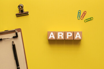 There is wood cube with the word ARPA. It is an abbreviation for Average Revenue per Account as...