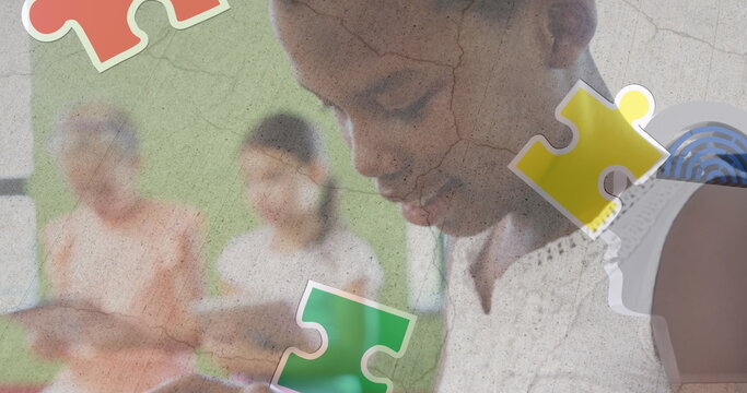 Jigsaw puzzle and human head icon over african american girl using digital tablet at school