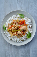 Chicken Szechuan with long grain steamed rice and baby spinach leaves.