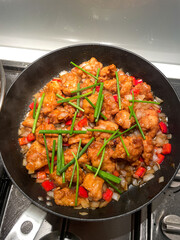 Fried chicken on a frying pan.
