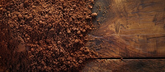 Close up view of ground coffee on a wooden backdrop with copy space image