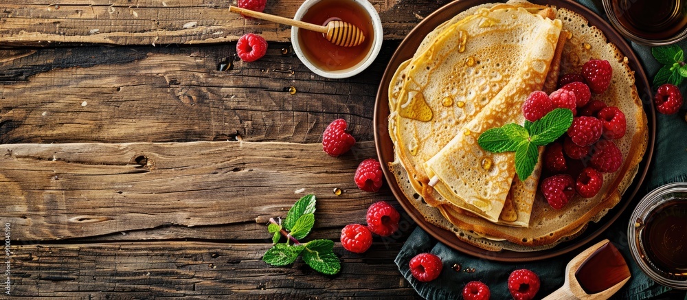 Aufkleber rural breakfast spread viewed from the top thin crepes or pancakes with raspberries honey and mint o