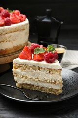 Tasty sponge cake with fresh berries and mint served on black table, closeup