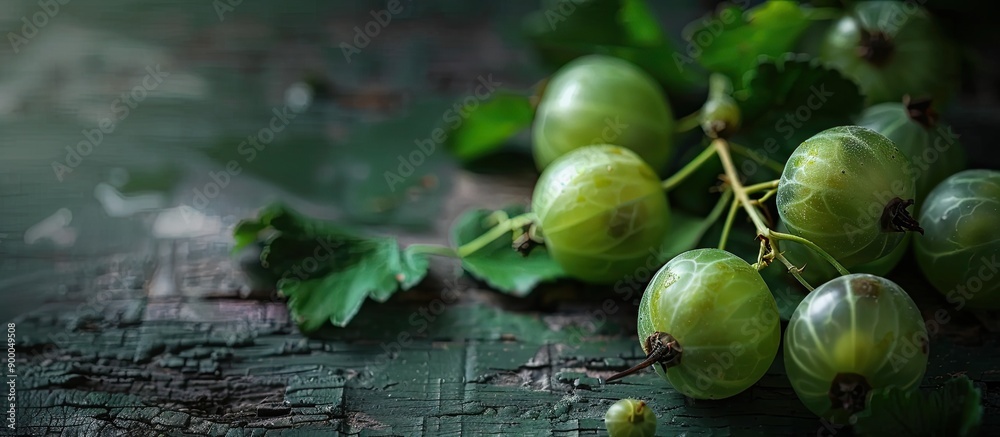 Aufkleber a ripe agrus or gooseberry displayed on a dark wooden surface with copy space image