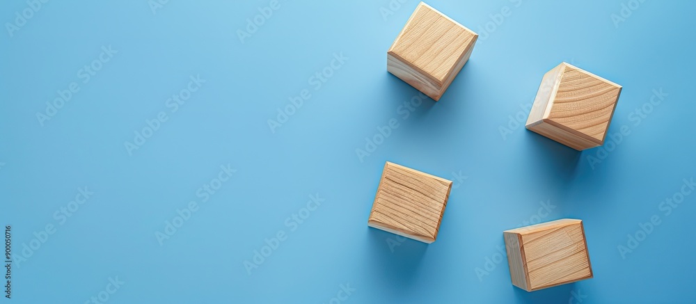 Aufkleber A bird s eye view of three empty wooden cubes on a blue backdrop with copy space image