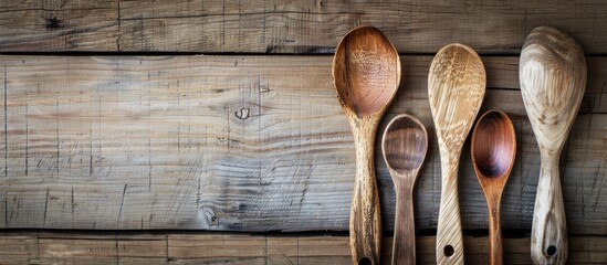 Cooking spoons displayed against a wooden backdrop with copy space image available